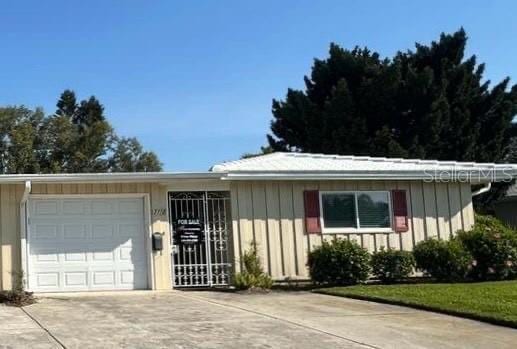 ranch-style home with a garage and driveway