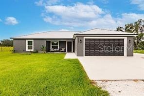 ranch-style house with a front yard and a garage