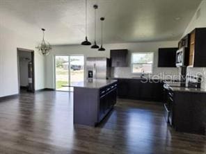 kitchen featuring appliances with stainless steel finishes, plenty of natural light, and dark hardwood / wood-style flooring