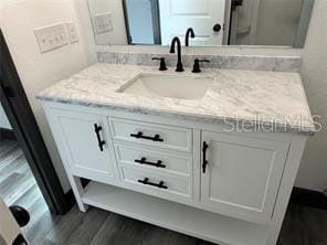 bathroom featuring vanity and wood finished floors