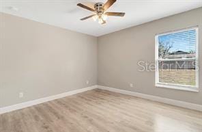 empty room featuring baseboards, ceiling fan, and wood finished floors