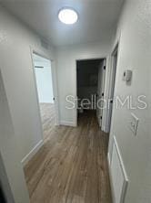 hall with wood finished floors and baseboards