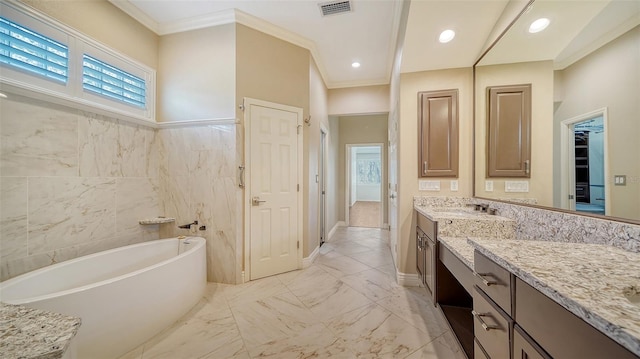 bathroom featuring crown molding, a bathing tub, vanity, and tile walls