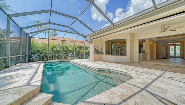 view of swimming pool featuring ceiling fan, a patio area, a lanai, and pool water feature