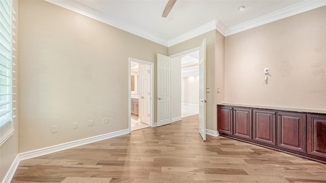 corridor with ornamental molding and light wood-type flooring