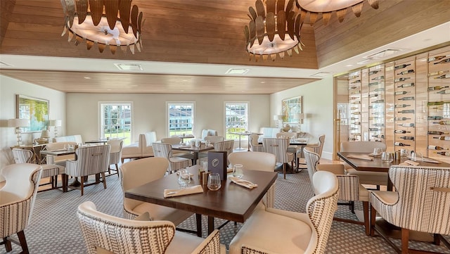 dining space with carpet and wooden ceiling