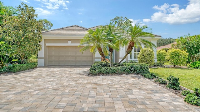 view of front of property with a garage and a front yard