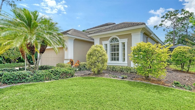 exterior space featuring a lawn and a garage