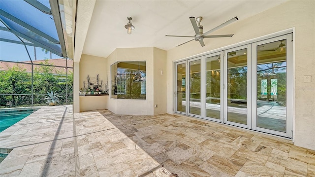 view of patio with glass enclosure, ceiling fan, and french doors