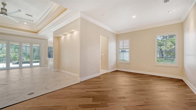 spare room featuring light wood-type flooring, ceiling fan, and crown molding