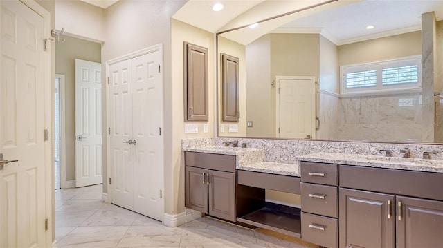 bathroom featuring ornamental molding and vanity