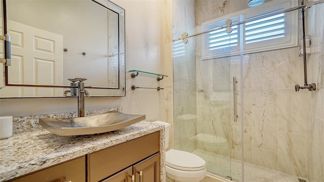 bathroom featuring walk in shower, vanity, and toilet