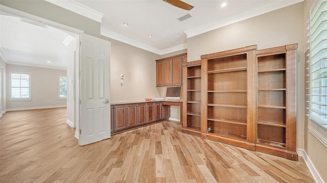 interior space with light hardwood / wood-style flooring, built in desk, ceiling fan, and ornamental molding