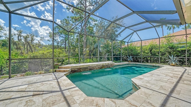 view of pool featuring a lanai, pool water feature, and a patio area