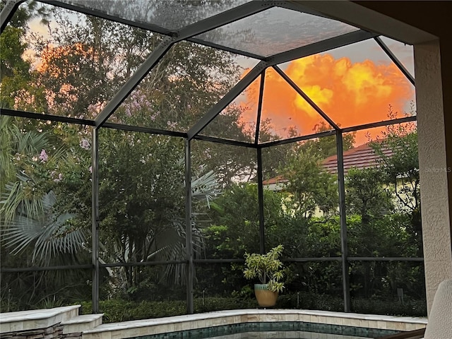 pool at dusk with glass enclosure