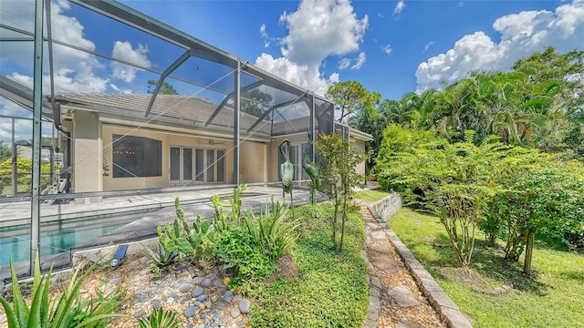 rear view of house featuring a lanai and a patio area