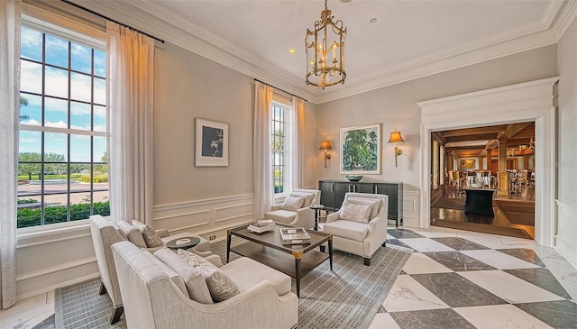 living area with ornamental molding and an inviting chandelier