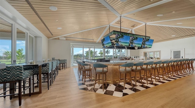 bar featuring high vaulted ceiling, light hardwood / wood-style floors, and wooden ceiling