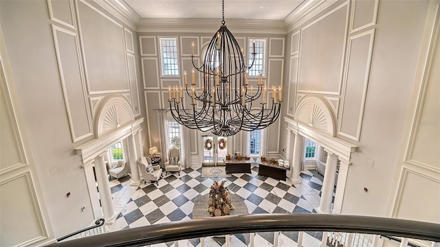 interior details featuring crown molding and an inviting chandelier