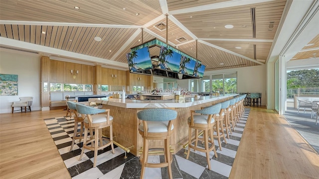 kitchen with high vaulted ceiling, a wealth of natural light, wooden ceiling, and light wood-type flooring