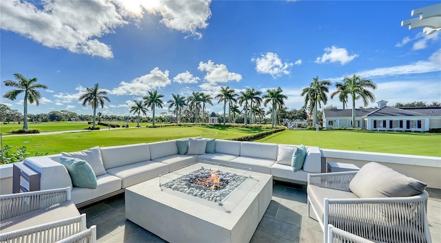 view of patio with an outdoor living space with a fire pit