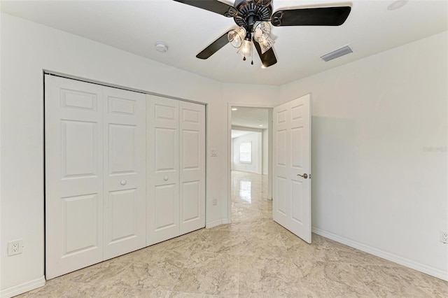 unfurnished bedroom with ceiling fan and a closet