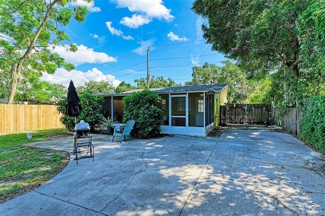 view of patio / terrace featuring a sunroom