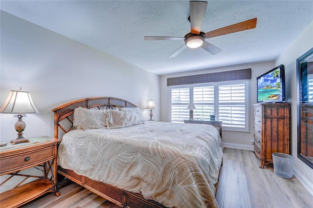 bedroom featuring light hardwood / wood-style floors and ceiling fan