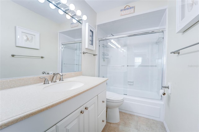 full bathroom with tile patterned floors, enclosed tub / shower combo, vanity, and toilet