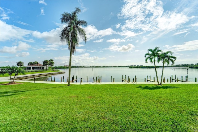 dock area featuring a water view and a yard