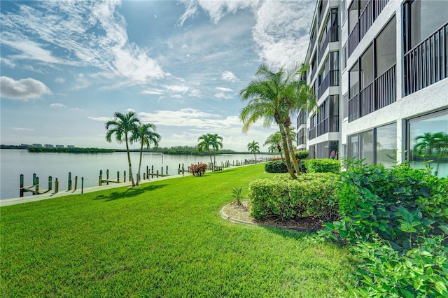view of yard with a dock and a water view