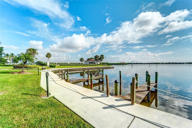 dock area featuring a lawn and a water view