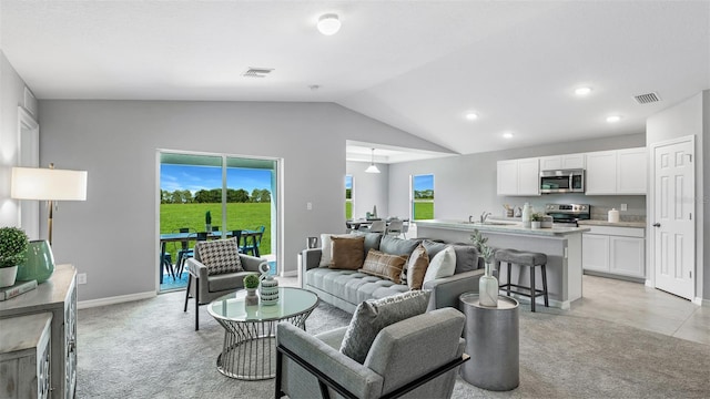 living room featuring vaulted ceiling, light colored carpet, and a wealth of natural light