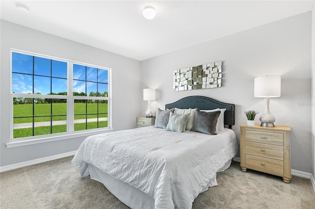 bedroom featuring light colored carpet