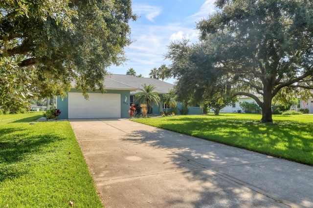 view of front of property with a front yard and a garage