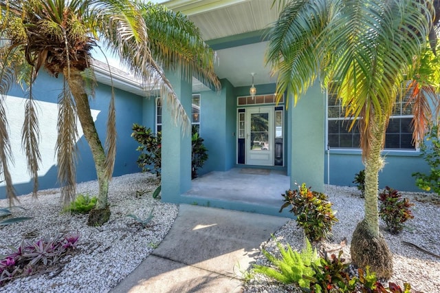 view of exterior entry with covered porch