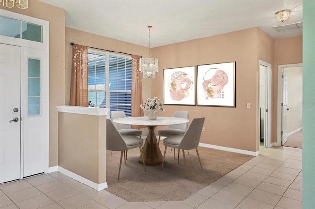 dining room featuring a notable chandelier and light tile patterned floors