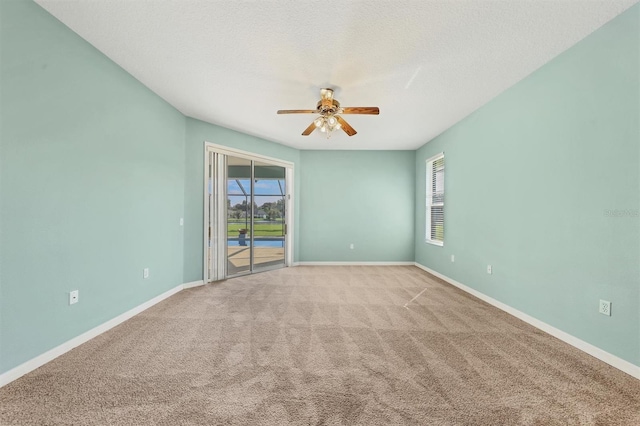 carpeted empty room with a textured ceiling and ceiling fan