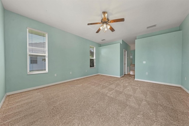 spare room with light carpet and ceiling fan