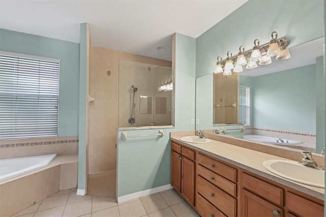 bathroom with tile patterned flooring, independent shower and bath, and vanity