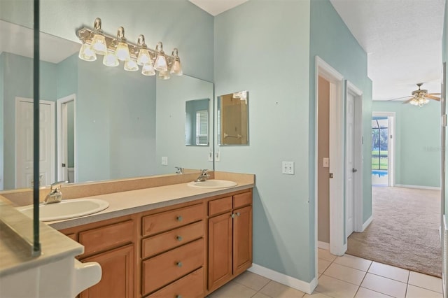 bathroom featuring a textured ceiling, vanity, ceiling fan, and tile patterned floors