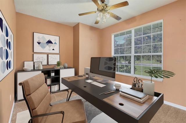 carpeted office featuring ceiling fan