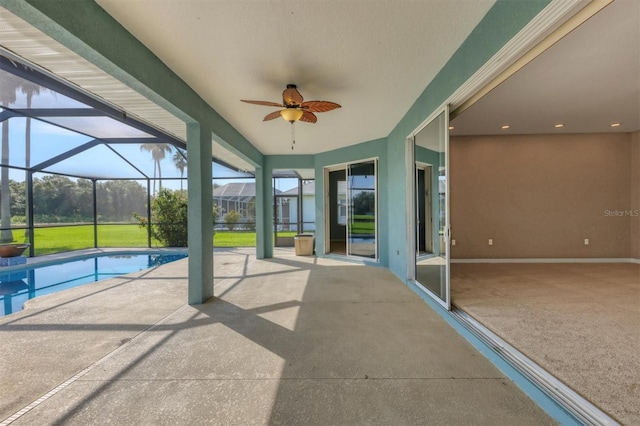 view of patio / terrace featuring glass enclosure and ceiling fan