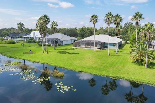 view of home's community featuring a lawn and a water view