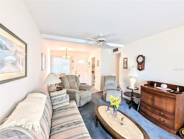 carpeted living room with ceiling fan with notable chandelier