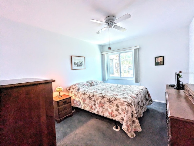 bedroom with dark colored carpet and ceiling fan