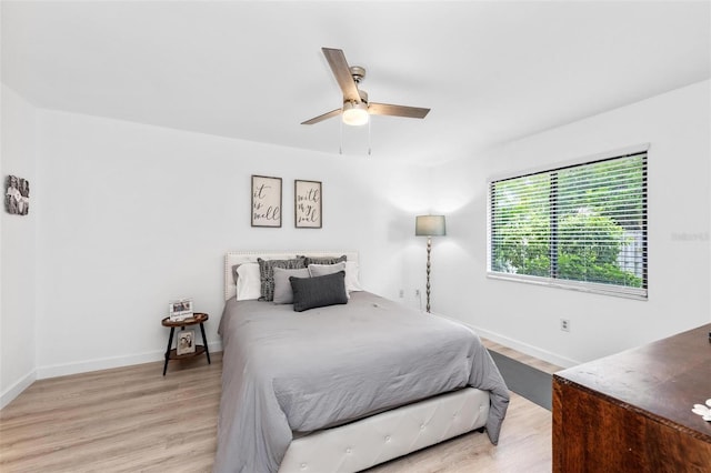 bedroom with ceiling fan and light wood-type flooring