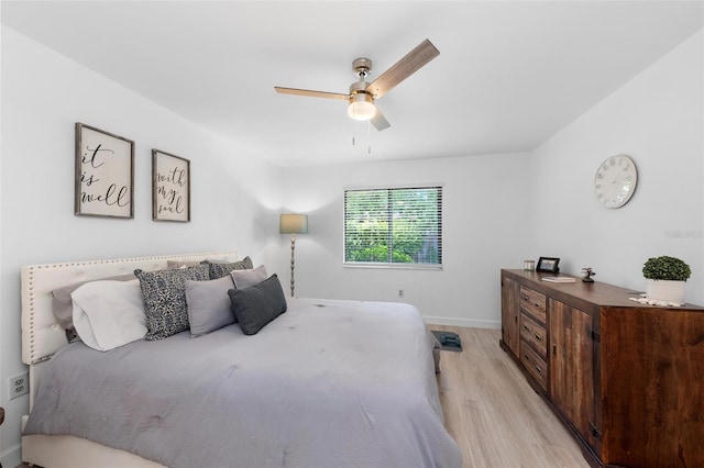 bedroom with light hardwood / wood-style floors and ceiling fan