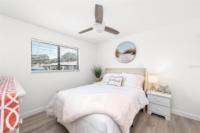 bedroom with ceiling fan and light hardwood / wood-style floors