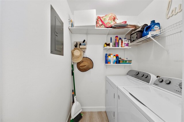 6050 28th St W Unit 14B, Bradenton, FL 34207 - washroom with laundry area, washer and clothes dryer, light wood-style flooring, and electric panel